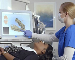 Dentist showing patient digital dental impressions