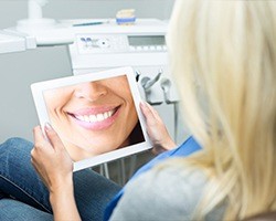 Woman looking at digital image of her smile