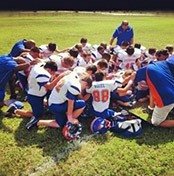 Football team in huddle before game