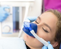 Female dental patient with nitrous oxide sedation dentistry nose mask