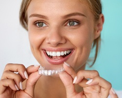 Woman putting in a teeth whitening tray 