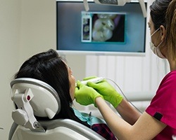 Patient and dentist looking at intraoral photos