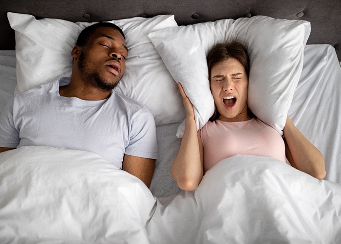  A snoring man and his frustrated wife