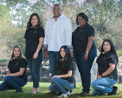 Louetta dentist and dental team members at the Castleberry Center smiling outdoors