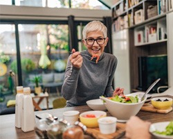 Woman smiling while eating lunch with friend