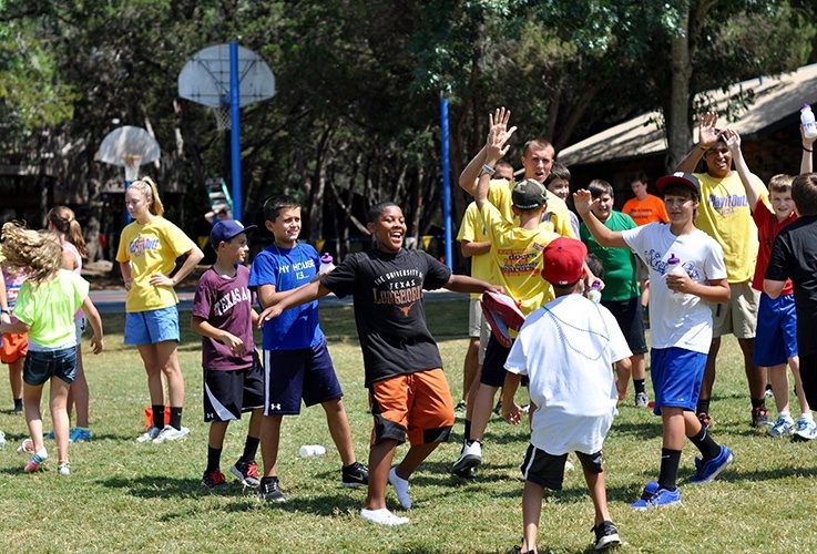 Team members working with kids in sports program