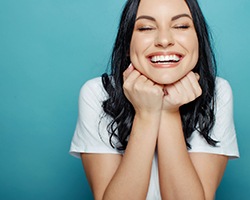 a woman smiling after undergoing cosmetic dentistry in Louetta