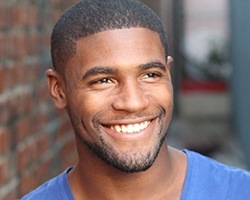 Young man with attractive smile after teeth whitening