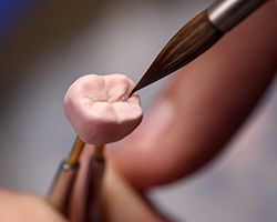 a dental lab technician crafting a crown