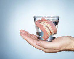 dentures in a glass of water