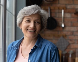 Woman with dentures in Louetta smiling