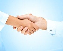 Patient and dentist shaking hands after dentures in Louetta