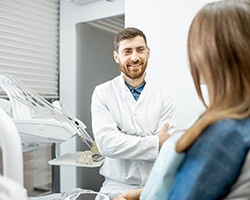 dentist talking to patient about getting dental implants in Houston