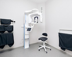 A dentist showing a patient a model of dental implants in the jaw