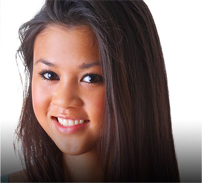 Young woman with straight black hair grinning