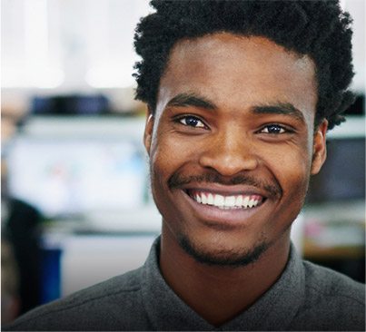 Young man in gray shirt smiling