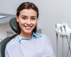Female laser dentistry patient with brown hair and happy smile
