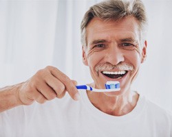 Man holding toothbrush and toothpaste