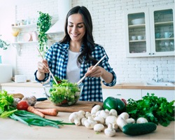 Woman making a salad with vegetables