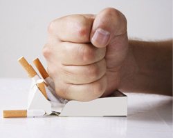 Man crushing pack of cigarettes