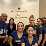 Smiling dentist and dental team in dental office