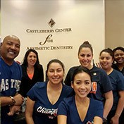 Smiling Louetta dentist and dental team in dental office