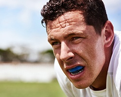 Closeup of man wearing mouthguard outside