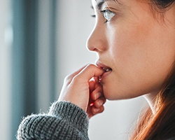 Closeup of woman biting her nails