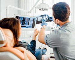 Dentist and patient reviewing X-ray together