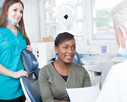 Dentist explaining cost of veneers in Louetta to a patient