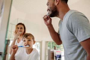 Family brushing their teeth