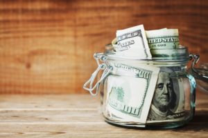 a jar of money being saved by visiting the dentist