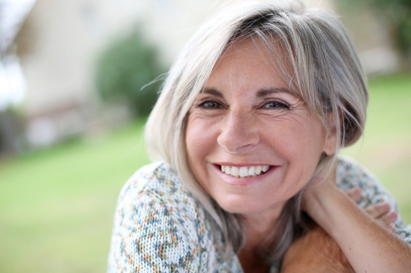 Closeup of senior woman smiling outside