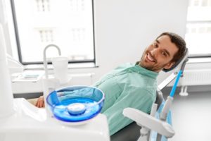 Male dental patient smiling after receiving dental implants