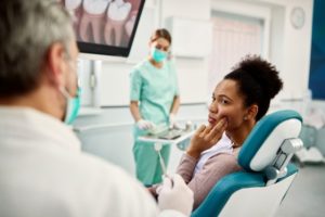 Woman in the dental chair who is experiencing dental pain