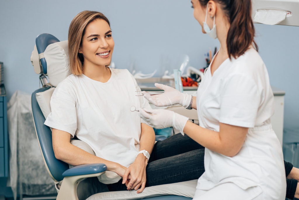 patient learning about importance of routine dental checkups in Houston