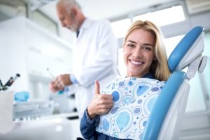 Woman smiling at her dental appointment.