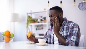 man with toothache and coffee