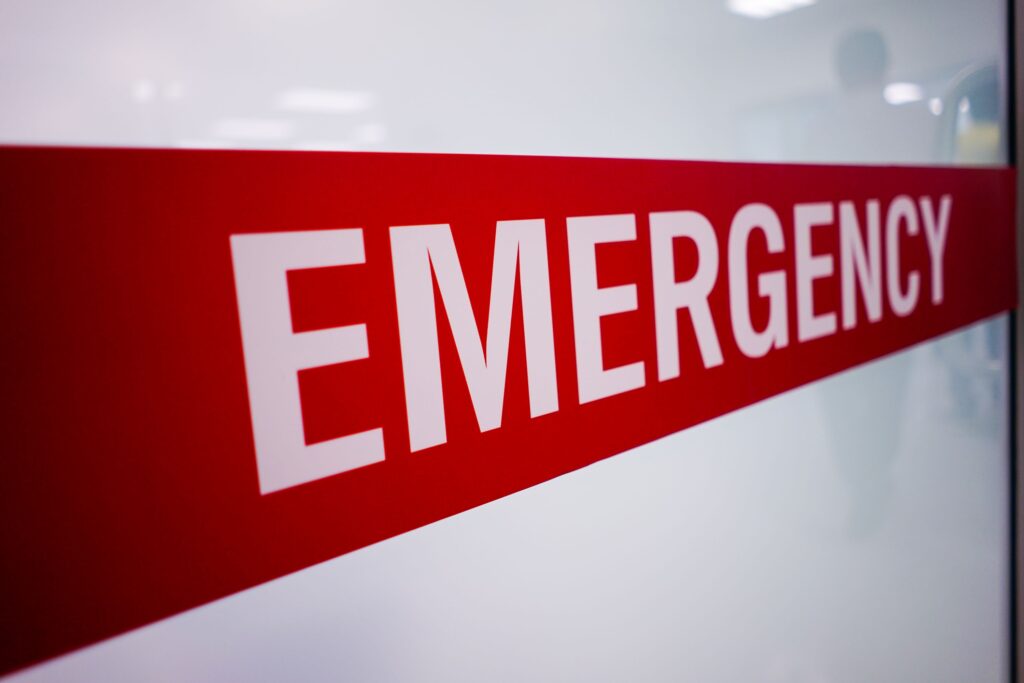 Red and white emergency label on wall