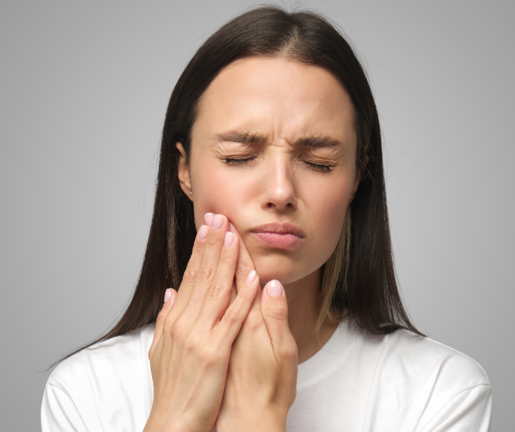 Woman holding jaw in pain