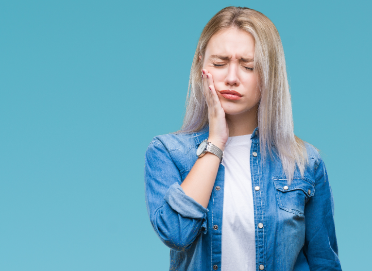 Woman holding jaw, in pain